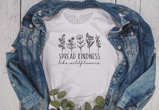 white unisex T-Shirt with wild flowers and under the flowers the saying Spread Kindness like wildflowers
