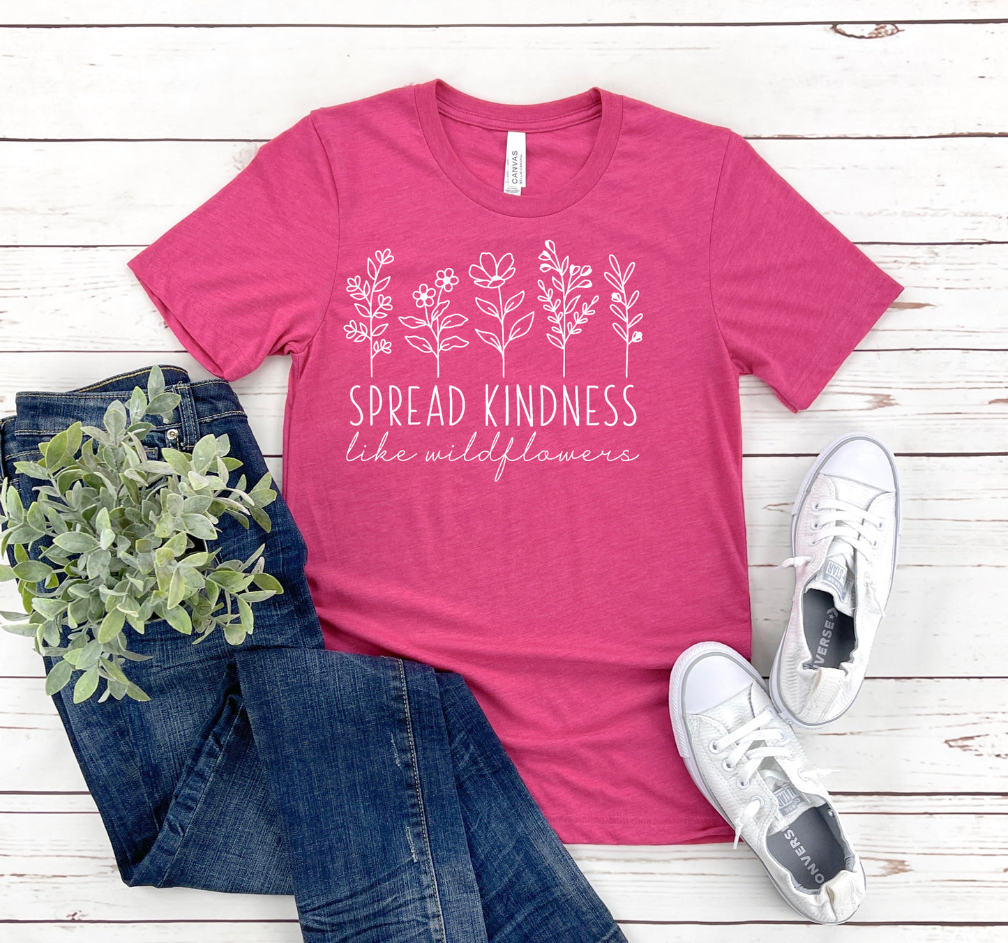 pink unisex fit T-Shirt with wildflower in white and the saying Spread Kindness like wildflowers
