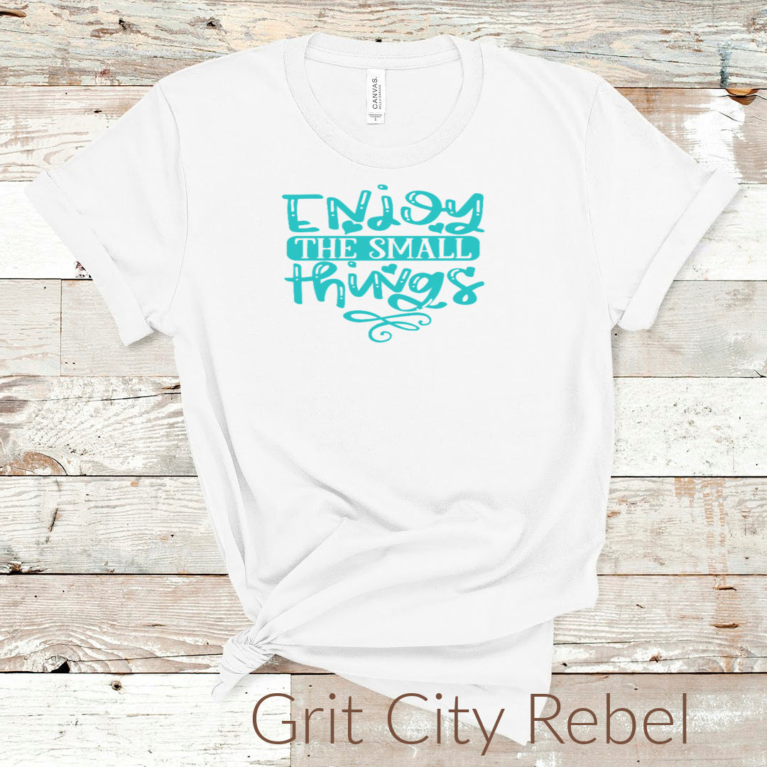 Grit City Rebel White T-Shirt with the saying Enjoy the Small Things written in turquoise.