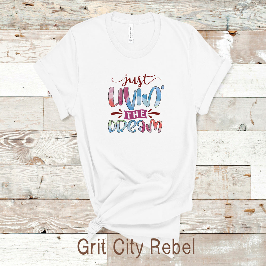 Just livin the dream white TShirt with coloed lettering sizes small, medium, large, Xlarge, 2X, 3X
