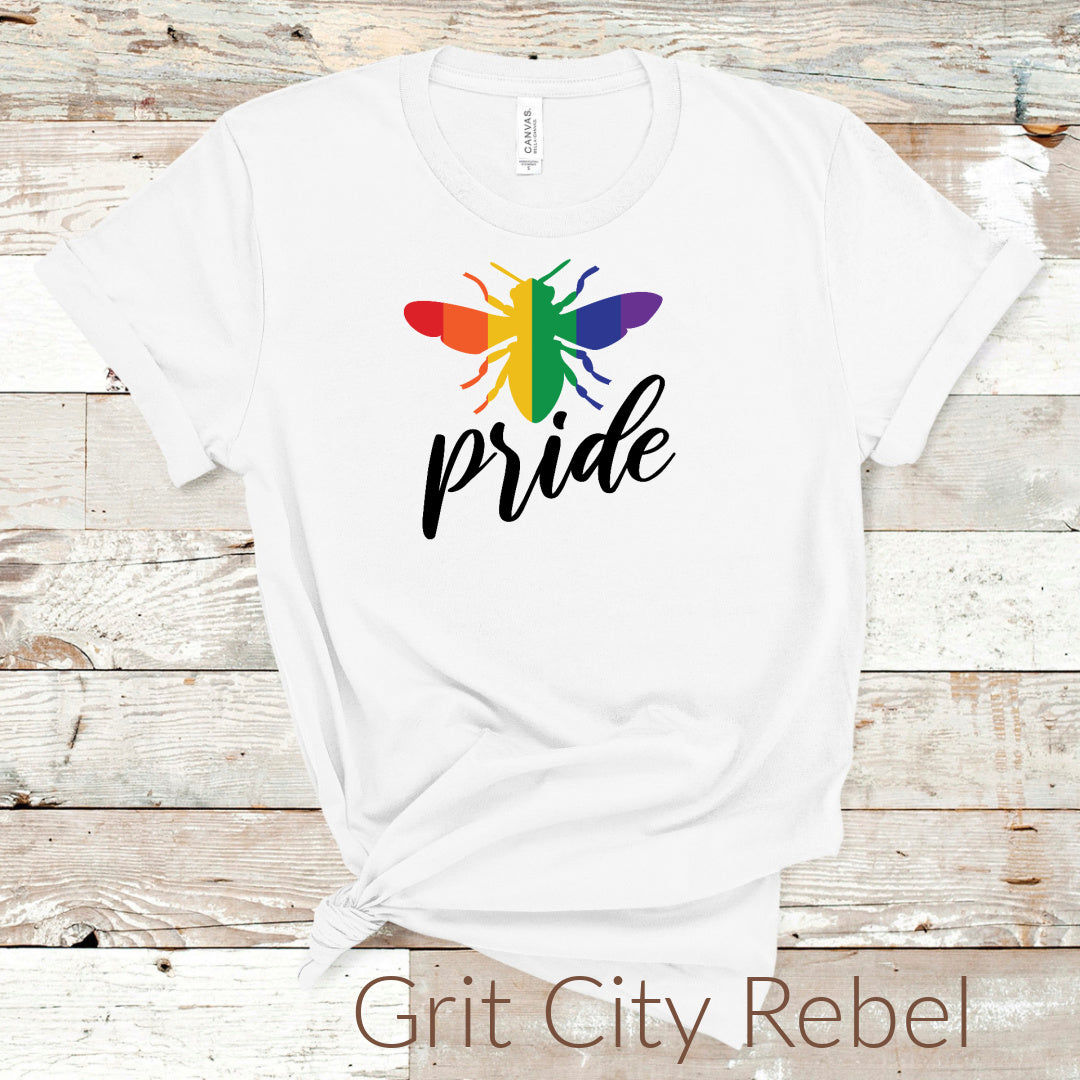 Grit City Rebel LGBTQIA2+ White TShirt with a rainbow colored Bee and the words Pride in black. Size Small to 3X