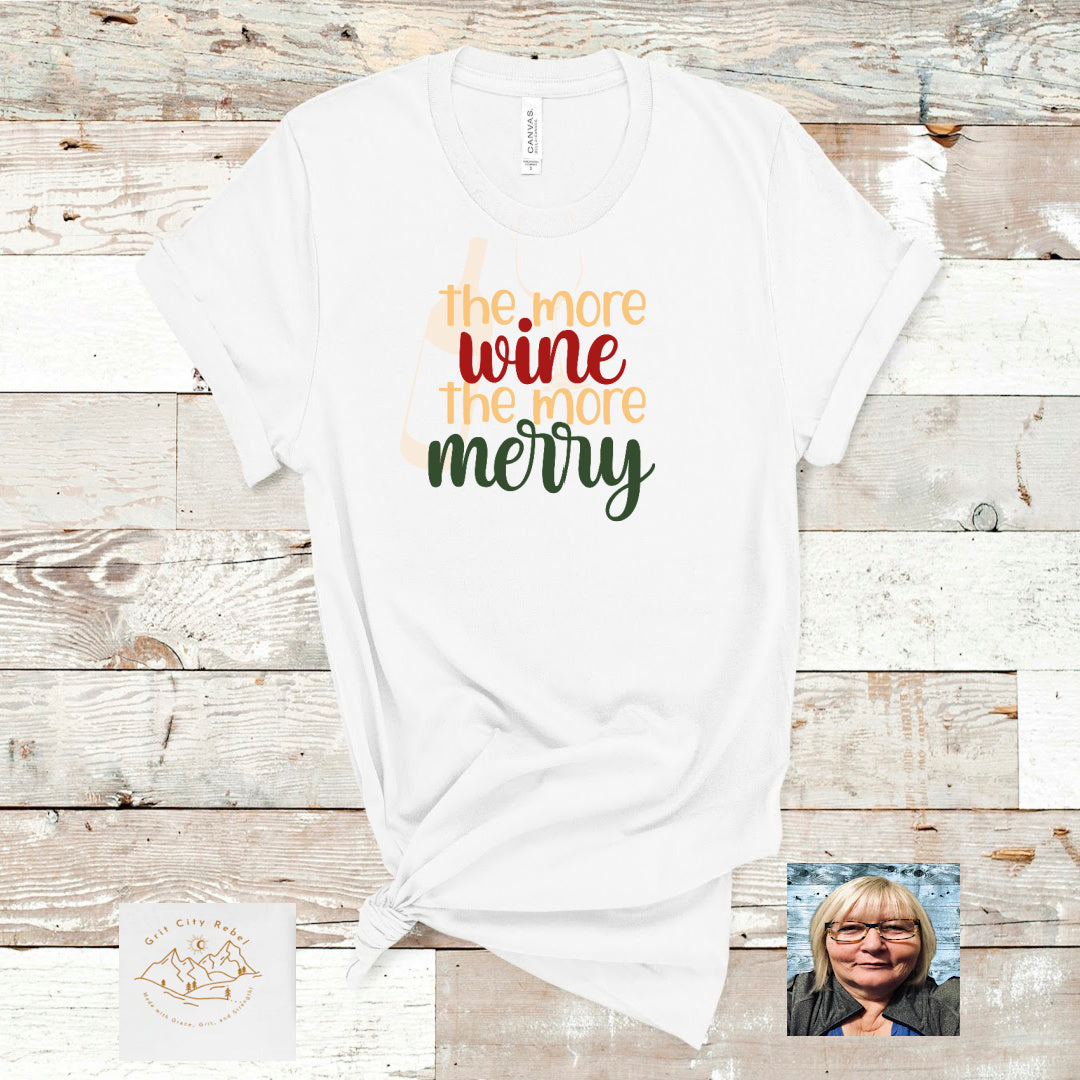 in colors of gold red green saying the more wine the more merry on a white unisex Tshirt Grit City Rebel