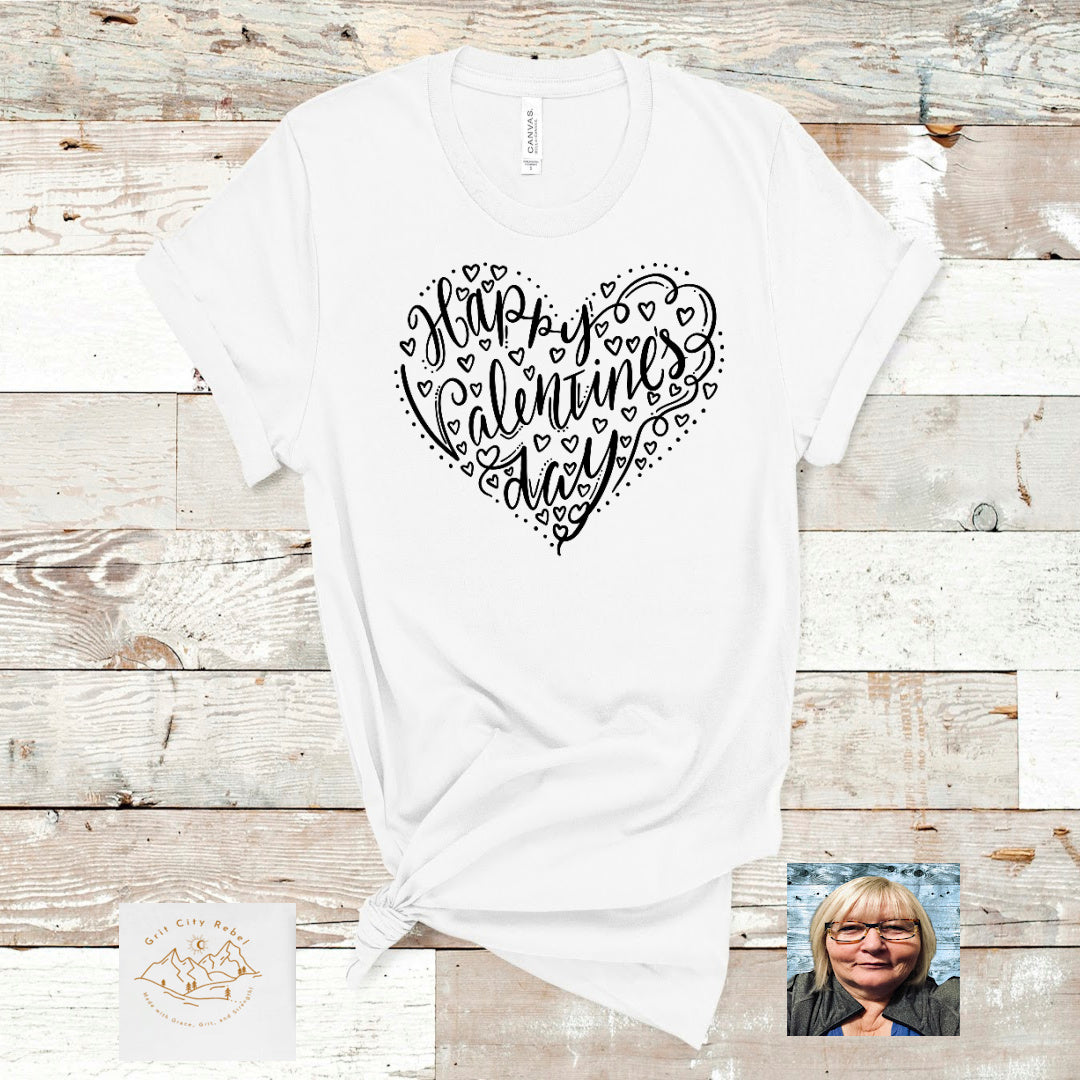 Happy Valentines Day within a heart in black writting on a unisex white Tshirt